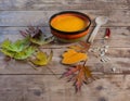 Pumpkin soup bowl on rustic wooden background Royalty Free Stock Photo