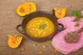 Pumpkin soup in clay pot with fresh pumpkins Royalty Free Stock Photo