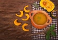 Pumpkin soup in clay pot with fresh pumpkins Royalty Free Stock Photo