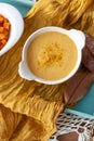 Top view Pumpkin soup cream in a white bowl spiced with curry. Delicius Pumpkin C