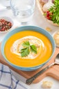 Pumpkin soup with cream and parsley on white background Royalty Free Stock Photo