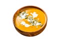Pumpkin soup with cream, seeds and fresh basil in rustic wooden bowl. Isolated on white background. Top view. Royalty Free Stock Photo
