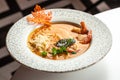 pumpkin soup with cream, shrimps in bowl on table Royalty Free Stock Photo