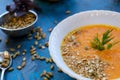 pumpkin soup with dill and young green onion feathers with pumpkin and corn in the background Royalty Free Stock Photo