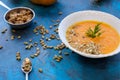 Tasty and delicious squash pumpkin soup with toasts, melted cheese, decorated with dill and pumpkin seeds Royalty Free Stock Photo