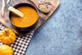 Pumpkin soup for Halloween and Thanksgiving party. Harvest and fall autumn season.
