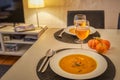 Pumpkin soup and potato with rosemary and bacon is a perfect autumnal recipe or meal for halloween served with a glass of beer Royalty Free Stock Photo