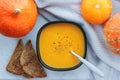 Pumpkin soup puree with croutons and pumpkins next, top view Royalty Free Stock Photo