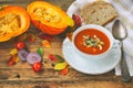 pumpkin soup puree in white bowl on wooden table Royalty Free Stock Photo