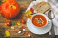 pumpkin soup puree in white bowl on wooden table Royalty Free Stock Photo