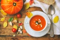 pumpkin soup puree in white bowl on wooden table top view Royalty Free Stock Photo