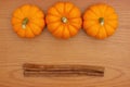 Pumpkin Spice background with a pumpkins and cinnamon sticks on wood Royalty Free Stock Photo