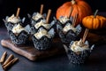 Pumpkin spice cupcakes and cinnamon sticks for garnish against a dark background Royalty Free Stock Photo