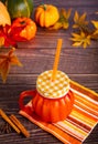 Pumpkin spice hot autumn drink beverage. Nearby fall leaves, pumpkins