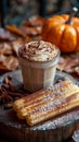 Pumpkin spice latte with churros, cozy autumn concept. Trendy Mexican food. Royalty Free Stock Photo