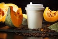 Coffee bean pumpkin spice latte nutrition recipie mock up. cut pumpkin coffee beans and white paper cup for coffee break