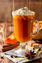 Pumpkin spice latte with whipped cream and cinnamon in glass on rustic wooden background Royalty Free Stock Photo