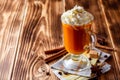 Pumpkin spice latte with whipped cream and cinnamon in glass on rustic wooden background Royalty Free Stock Photo