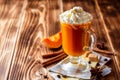 Pumpkin spice latte with whipped cream and cinnamon in glass on rustic wooden background Royalty Free Stock Photo