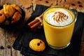 Pumpkin spice latte with whipped cream and pumpkin chocolate chi Royalty Free Stock Photo