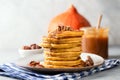 Pumpkin spice pancakes with pecan nuts and caramel sauce Royalty Free Stock Photo