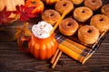 Pumpkin spice whipped latte in glass. Hot autumn drink beverage. Nearby delicious apple cider donuts Royalty Free Stock Photo