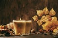 Pumpkin spiced latte or coffee in glass cup on vintage wooden table. Autumn or winter hot drinkÃâ¹ and beverages. Fall decor table Royalty Free Stock Photo