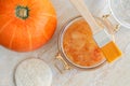 Pumpkin sugar scrub in a glass jar. Homemade beauty treatment and spa recipe. Top view