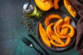 Pumpkin winter dessert. Baked pumpkin slices with honey and thyme on a stone countertop. Top view flat lay.