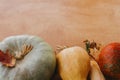 Pumpkins, autumn leaves, corn, walnuts,chestnuts,acorns border on rustic wooden table with space for text. Happy Thanksgiving. Royalty Free Stock Photo