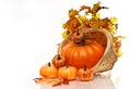 Pumpkins and Autumn leaves in a wicker basket.