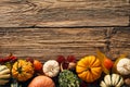 Pumpkins and autumn leaves on wooden table. Happy Thanksgiving Day greeting card template. Flat lay, top view, copy space Royalty Free Stock Photo