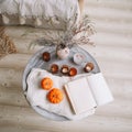 Pumpkins, candles, book and dried flowers with warm blanket. Autumn, fall, Halloween, Thanksgiving day concept. Flat lay, top view Royalty Free Stock Photo