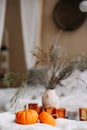 Pumpkins, candles and dried flowers with warm blanket. Autumn, fall, Halloween, Thanksgiving day concept. Flat lay, top view Royalty Free Stock Photo