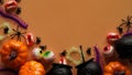 Pumpkins,cauldrons,pots,worms,jaws,spiders and candy in the form of eyes on a orange background,top view,copy space.Collection of Royalty Free Stock Photo