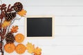 Pumpkins and Chalkboard over Wooden Background Royalty Free Stock Photo