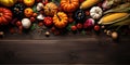 Pumpkins, corn and other vegetables lie on a wooden table, top view