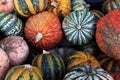 Pumpkins of different shapes and colors on the counter in the store to celebrate Halloween and on the streets of the city.