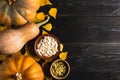 Pumpkins of different sizes on a black wooden background. Copy space. Top view. Royalty Free Stock Photo