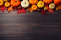 pumpkins with fall leaves on dark brown wooden ground, top view, fall background with space for text Royalty Free Stock Photo