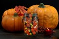 Pumpkins, Halloween candy and a lit candle