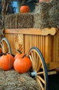 Pumpkins and hay bales decorate an autumn wagon Royalty Free Stock Photo