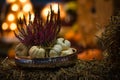 Pumpkins And Heather Flower Setting On A Stack Of Hay With Bokeh Lights, Decoration For Halloween, Autumn Harvest