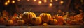 Pumpkins, leaves, and a wooden table with natural candle lightin