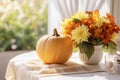 Pumpkins near yellow flowers bouquet on a table with white tablecloth. Farmhouse autumn centerpiece on blurred background. Royalty Free Stock Photo