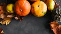 Autumn food background. Pumpkins, pears, autumn leaves on dark background. Royalty Free Stock Photo