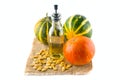 Pumpkins and pumpkin seed oil isolated on white Royalty Free Stock Photo