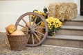 Pumpkins with rustic baskets, flowers and hay decoration outdoors. Stylish autumn decor of exterior Royalty Free Stock Photo