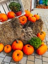 Pumpkins rustic hay decoration outdoors. Stylish autumn decor of exterior building. Rural decor on haystack in street Royalty Free Stock Photo