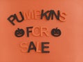 Pumpkins for sale sign with orange and black letters Royalty Free Stock Photo